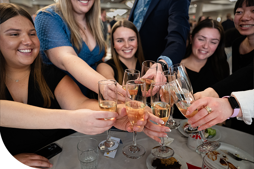 students toasting with champagne at senior toast
